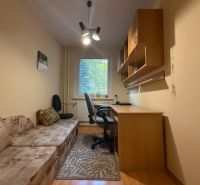 A workspace in a 3-room apartment with a sofa and a table with a shelf.