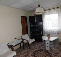 Living room in a family house with carpet and custom-made furniture.