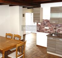 A kitchen in a family house with natural decor, brick cladding, and a wooden decor floor.