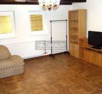 Living room in a family house with a shelving unit and a wooden decor floor.