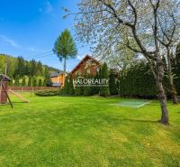 A garden with a lawn, playground, and trees in hotels and guesthouses in Makov.