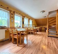 Bright dining room with wood-patterned flooring, ready to host guests.