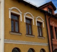 The building with a colorful facade and arched windows is located in Topoľčany.