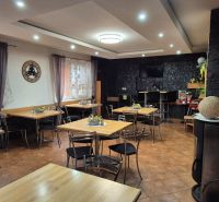 Commercial spaces with tables, chairs, and decorative curtains, with a wooden decor floor.