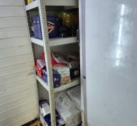 Storage space with shelves and consumer goods in commercial premises.