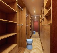 A hallway in a 3-room apartment with built-in wooden closets and a mirror.