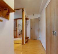 A hallway in a 3-room apartment with a wooden decor floor and a built-in wardrobe.