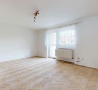 A bright room with a wood-patterned floor in a 3-room apartment.