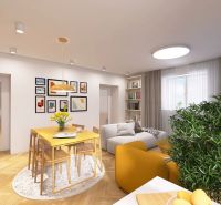 Living room in a 3-room apartment with wooden floor decor and yellow accents.