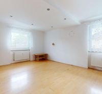 A room with a wooden floor design and white walls in a 3-room apartment.