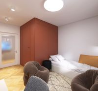 A bedroom in a 3-room apartment with a bed, a wooden decor floor, and a red wardrobe.
