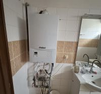 Bathroom with a gas boiler and a sink in a family house.