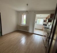 Room with wooden decor flooring, kitchen with a view, family house.