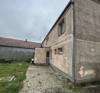 A family house in Veľká Čalomija with an older facade and a paved courtyard.