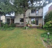 A family house in Leopoldov surrounded by a garden with a terrace and trees.