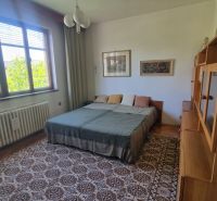 Bedroom in a family house with carpet decor and a large bed.