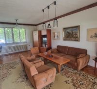 Living room of a family house with retro furniture and a wooden decor floor.
