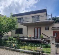 A family house in Leopoldov with a flat roof, a two-story terrace, and a green garden.