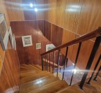 A staircase in a family house with wood decor and railing.