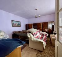 Living room with a sofa, cabinets, and a painting, floor with wood decor, Property - living.