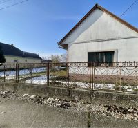 A family house in Vrakúňa with a white facade, lawn, and decorative fence.
