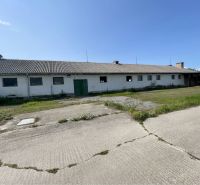 Production premises at Amadeho Kračany in Kostolné Kračany with a concrete area and a green gate.