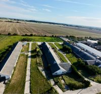 Production premises in Amadeho Kračany in Kostolné Kračany surrounded by agricultural fields.