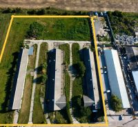 Production facilities at Amadeho Kračany in Kostolné Kračany, with three buildings surrounded by greenery.