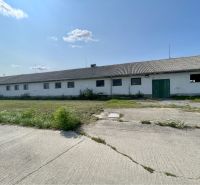 Production premises on Amadeho Kračany in Kostolné Kračany with grassy surroundings and an asphalt area.