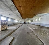 A space with a concrete floor and wooden crates in a manufacturing area.