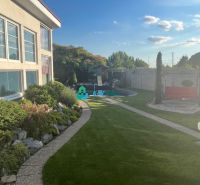 A garden at a family house in Orechová Potôň with a well-maintained lawn and walkway.