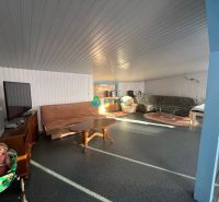 Living room with a television, sofa, and armchairs, Family house, floor with wood decor.