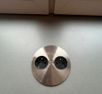 A metal drawer built into the desktop under the window in a studio apartment.