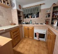 A kitchen in a family house with a wooden decor floor and preserved coziness.