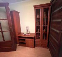 Dark wood furniture, wood-patterned flooring in the interior of a family house.