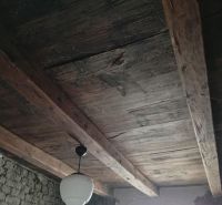 Wooden ceiling and old plaster in the interior of a family house.