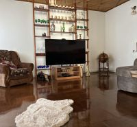 Living room in a family house with wooden decor and comfortable seating.