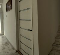 Interior of a family house with a hallway, staircase, and floor with wooden decor.
