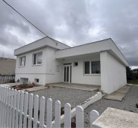 A family house in Trstice with a white facade and a gravel courtyard.