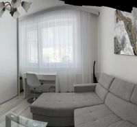 A sofa set with a desk, a cabinet with a geometric pattern in a family house.