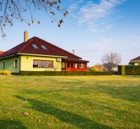 A family house in Dolný Bar on Dolný Bar Street with a well-maintained lawn and trees.