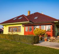 A family house in Dolný Bar on Dolný Bar Street, surrounded by a well-maintained green garden.