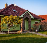 A family house in Dolný Bar on Dolný Bar Street with a red roof and a landscaped garden.