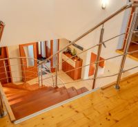 Interior of a family house with a staircase and a wooden decor floor.
