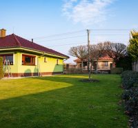 A family house in Dolný Bar with a well-maintained garden, trees, and shrubs on Dolný Bar street.