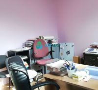 Offices with purple walls, a desk, and a wood-patterned floor.