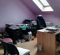 Offices with wood-patterned flooring and a skylight, furnished with furniture and chairs.