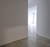 A bright hallway of a 3-room apartment with tiles leads to a sunlit room.