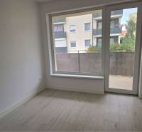 A room in a 3-room apartment with a floor featuring a wooden decor and balcony doors.