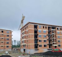 Construction of apartment buildings in Dunajská Streda; 2-room apartments; crane on the construction site.